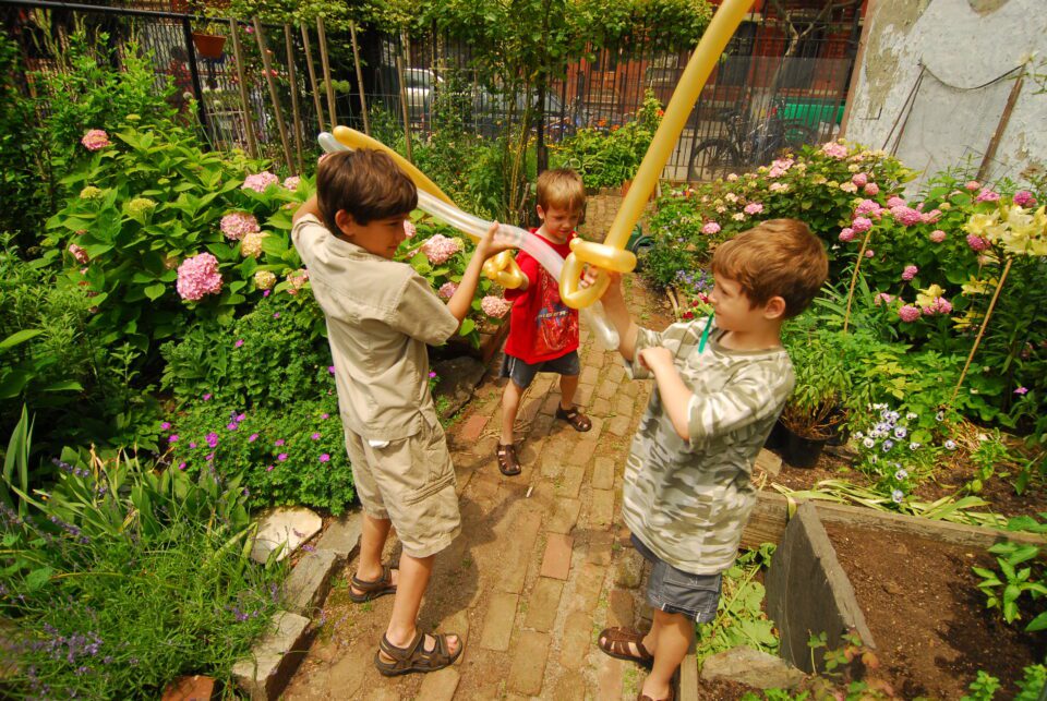 Kids play in a New York City garden.