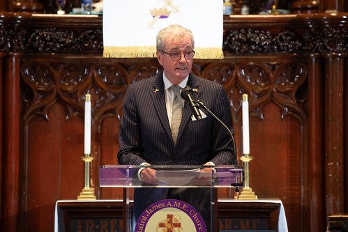 New Jersey Governor Phil Murphy standing in front of a podium delivering remarks.