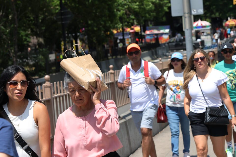 A photo of people in sweltering heat.