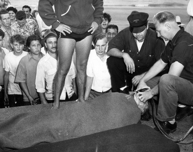 Inhalator squads work on fisherman John Jaworski, 52, at North Avenue beach after a huge wave hit the lake front and killed eight people on June 26, 1954. Jaworski was swept off the pier and was one of the eight people killed. (Chicago Tribune historical photo)