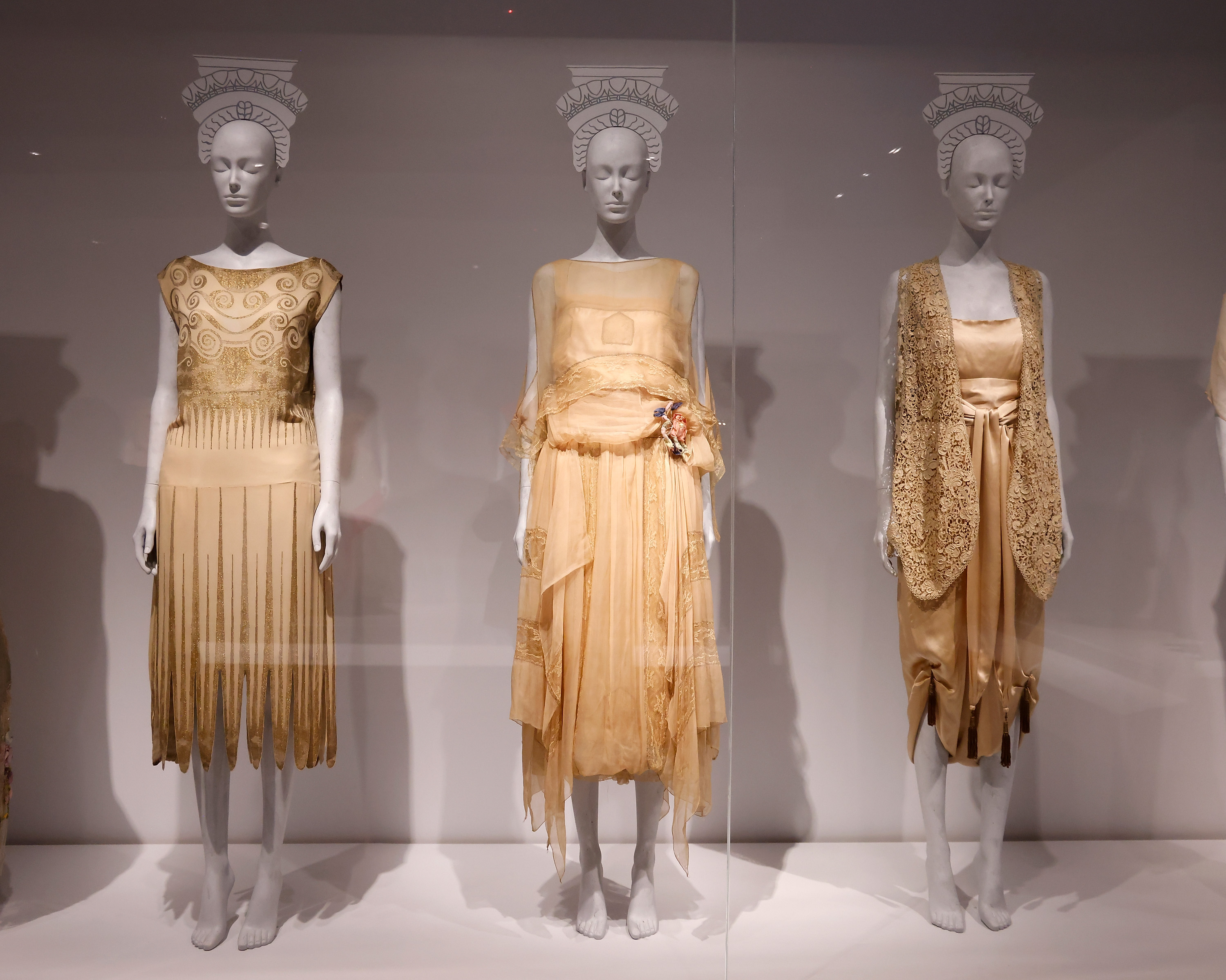 A collection of gold dresses.