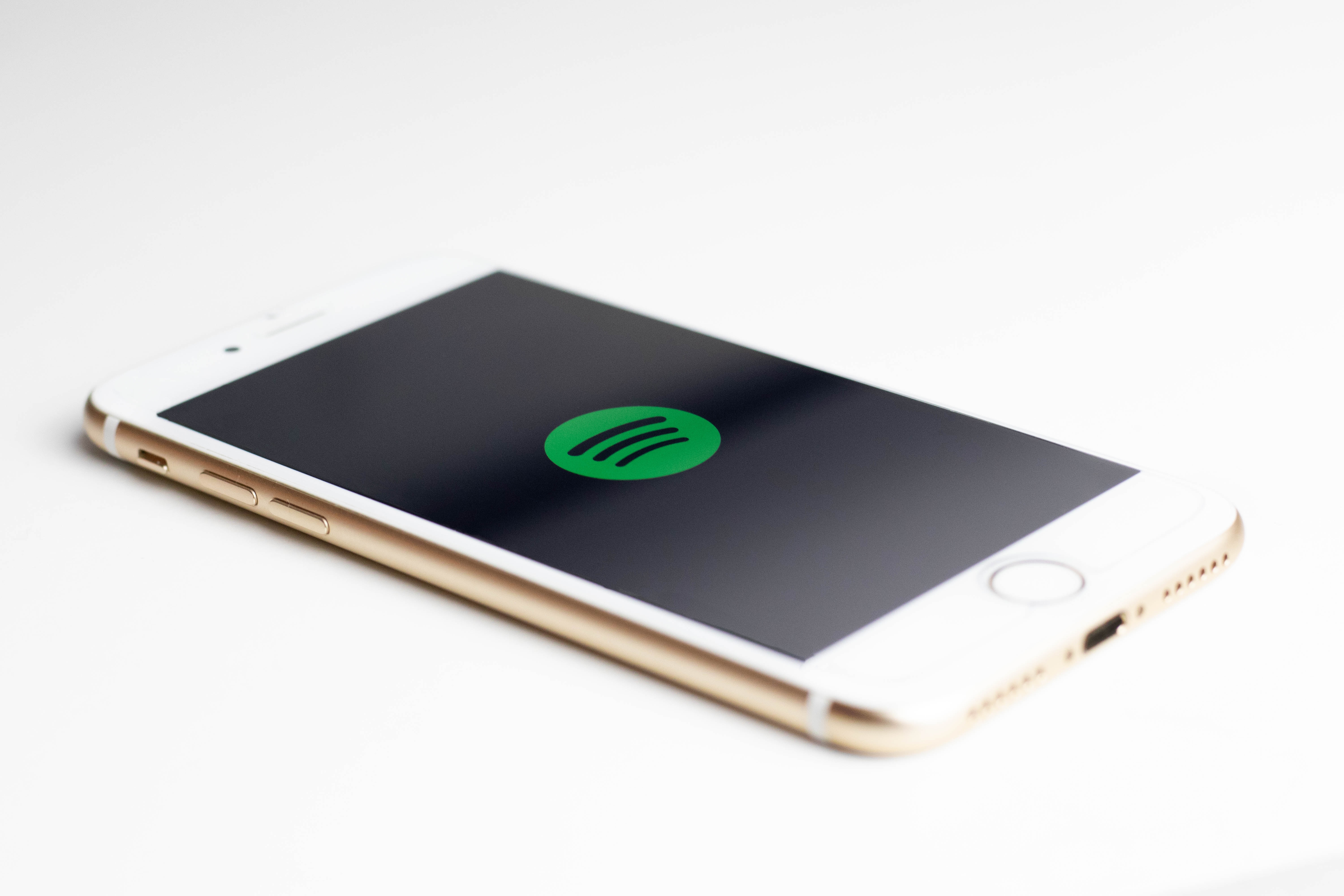 A Spotify logo on an iPhone.