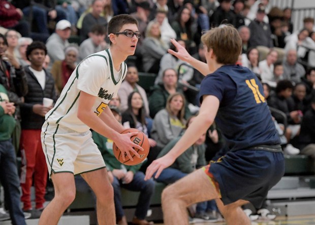 Waubonsie Valley's Ryan Morton (5) looks for an open against Neuqua Valley's Whitman Charboneau (11) at home in Aurora on Friday, Jan. 5, 2024. (Mark Black / The Beacon-News)