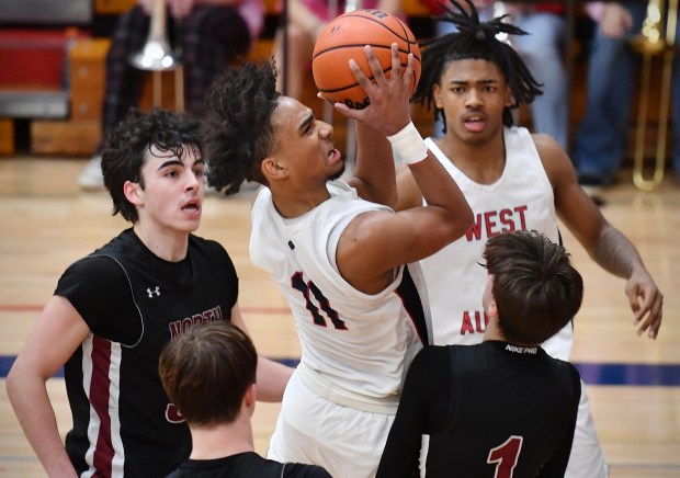 West Aurora's Jordan Brooks (11) goes to the basket in a crowd during a game against Plainfield North in Aurora on Friday, February 9, 2024.(Jon Cunningham for The Beacon-News)