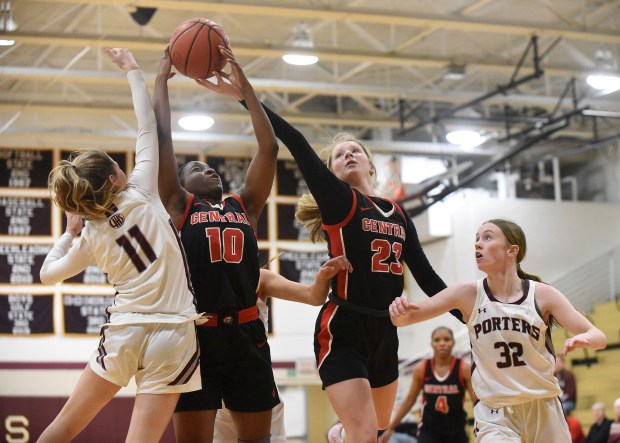 Lincoln-Way Central's Kiya Newson (10) and Brooke Baechtold (23) try to grab the rebound away from Lockport's Addison Foster (11) and Lucy Hynes (32) Monday, November 28, 2022 in Lockport, IL. (Steve Johnston / Daily Southtown)