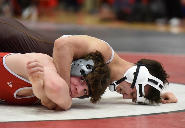 Mt. Carmel's Evan Stanley wrestles and defeats Marist's Ethan Sonne 7-2 at 132 pounds during the Class 3A Hinsdale Central Sectional Saturday, February 10, 2024 in Hinsdale, IL. (Steve Johnston/Daily Southtown)