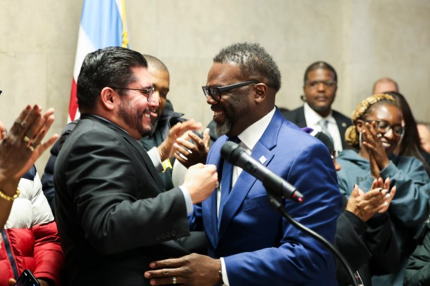 Ald. Carlos Ramirez Rosa, 35th, celebrates with Mayor Brandon Johnson and members of the Bring Chicago Home coalition during a press conference after a Chicago City Council committee advanced an ordinance that would ask voters about raising the real estate transfer tax to combat homelessness, Oct. 31, 2023.
