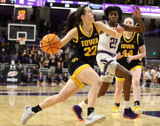 Iowa Hawkeyes guard Caitlin Clark drives to the basket while being defended by Northwestern Wildcats guard Melannie Daley in the second half at Welsh-Ryan Arena on Jan. 31, 2024, in Evanston.