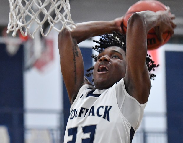 Oswego East's Jehvion Starwood delivers a dunk shot during a game in Oswego on Tuesday, February 13, 2024.(Jon Cunningham for The Beacon-News)