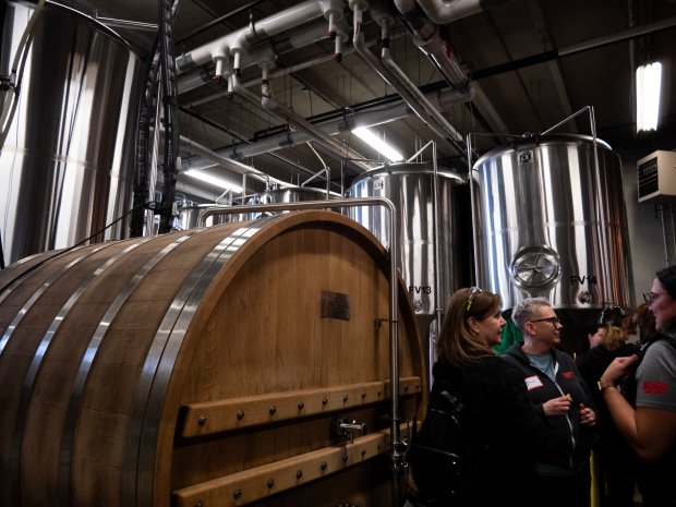 Women from dozens of beer organizations from across the Chicago area network at brew day held at Solemn Oath Brewery on Tuesday. (Tess Kenny/Naperville Sun)