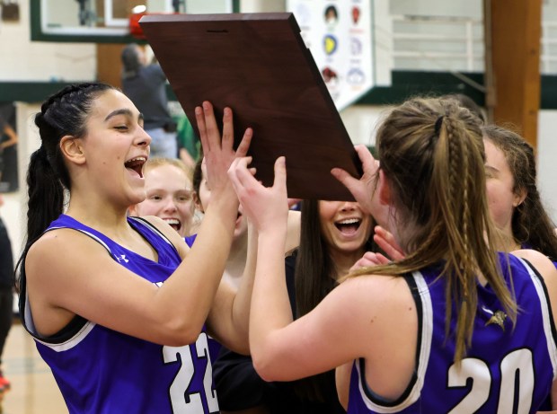 Geneva's Leah Palmer with teammates celebrate their win over Glenbard West during the girls Class 4A Regional final basketball game in Glen Ellyn, Ill Thursday, February 15, 2024. (James C. Svehla-Beacon News)