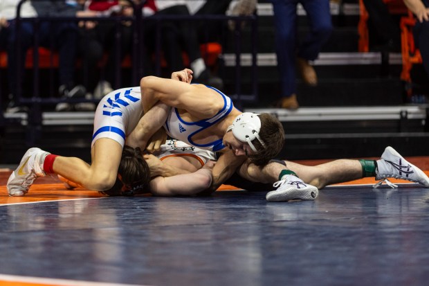 Marmion's Nicholas Garcia holds down St. Charles East's Dom Munaretto during the 113 pound bout in the class 3Astate wrestling championship at the State Farm Center at University of Illinois in Champaign on Saturday, Feb. 17, 2024. (Vincent D. Johnson / Daily Southtown).