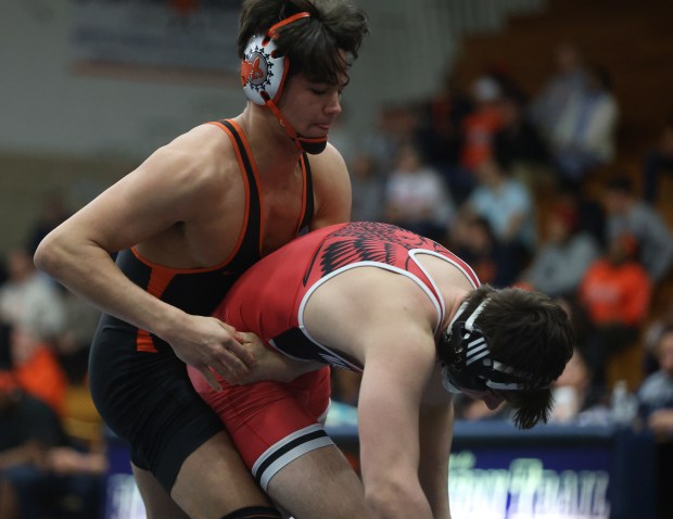 St. Charles East's Anthony Gutierrez attempts to wrap up Maine South's Aidan Swenson, left, in the 165 pound bout during the Class 3A Addison Trail Dual Team Wrestling Sectional at Addison Trail High School in Addison on Tuesday, Feb. 2024.