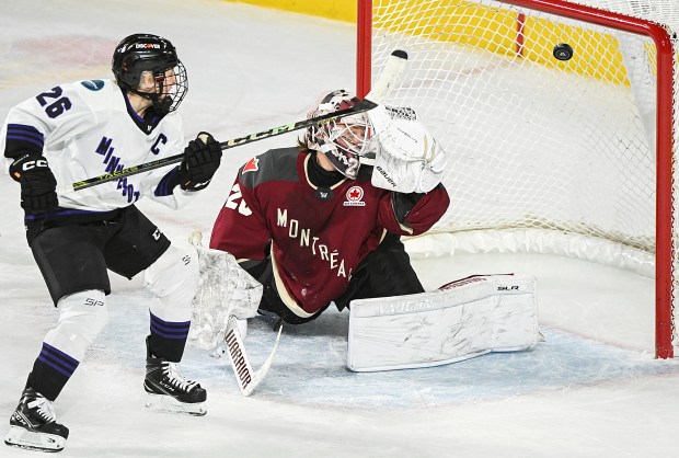 Minnesota's Kendall Coyne Schofield scores against Montreal goaltender Elaine Chuli during a PWHL game in Laval, Quebec, on Feb. 18, 2024. (Graham Hughes/The Canadian Press via AP)