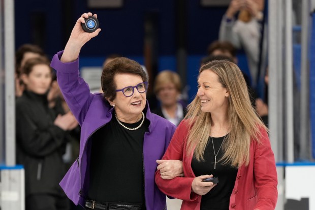 PWHL board member Billie Jean King, left, and league executive Jayna Hefford get set for the ceremonial faceoff before the inaugural game between New York and Toronto on Jan.1, 2024, in Toronto. (Frank Gunn/The Canadian Press via AP)