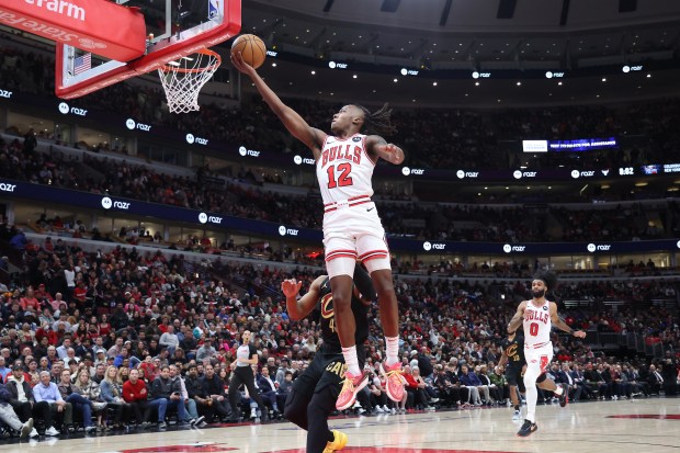 Bulls guard Ayo Dosunmu (12) soars to the rim for an easy layup against the Cavaliers on Feb. 28, 2024, at the United Center. (Terrence Antonio James/Chicago Tribune)