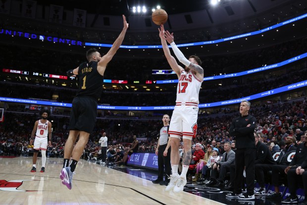 Bulls forward Onuralp Bitim (17) shoots over Cavaliers guard Max Strus on Feb. 28, 2024, at the United Center. (Terrence Antonio James/Chicago Tribune)