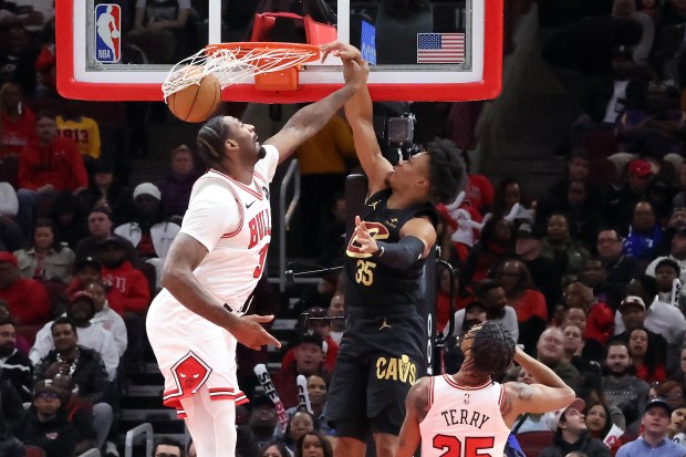 Cavaliers forward Isaac Okoro (35) dunks on Bulls center Andre Drummond on Feb. 28, 2024, at the United Center. (Terrence Antonio James/Chicago Tribune)