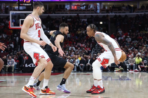 Bulls forward DeMar DeRozan (11) dribbles behind his back as Cavaliers guard Max Strus (1) defends on Feb. 28, 2024, at the United Center. (Terrence Antonio James/Chicago Tribune)