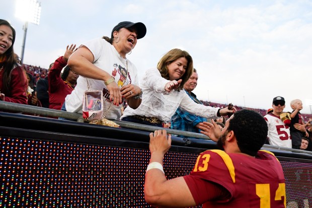 Southern California quarterback Caleb Williams, right, greets his mother, Dayne Price, left, after the team's 38-20 loss to UCLA during an NCAA college football game, Saturday, Nov. 18, 2023, in Los Angeles. (AP Photo/Ryan Sun)