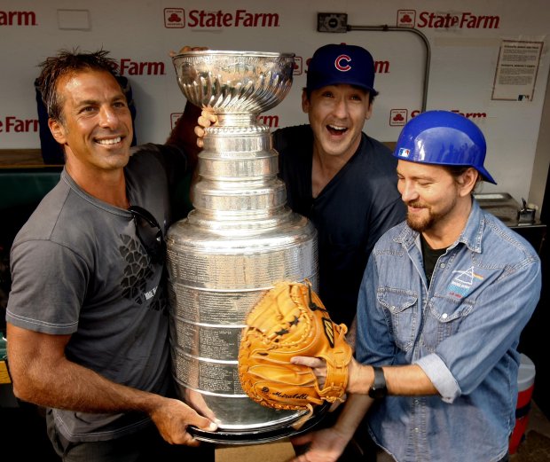 Former Chicago Blackhawks star Chris Chelios, from left, actor John Cusak and Pearl Jam frontman Eddie Vedder pose with the Stanley Cup before a Cubs-Nationals game on Aug. 22, 2008 at Wrigley Field. (Phil Velasquez/Chicago Tribune)