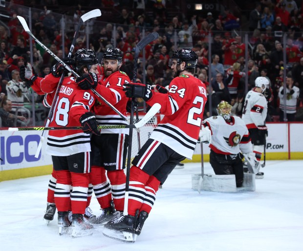Blackhawks left wing Nick Foligno celebrates with teammates Connor Bedard (98) and Jaycob Megna (24) after scoring in the first period against the Senators on Feb. 17, 2024, at the United Center.