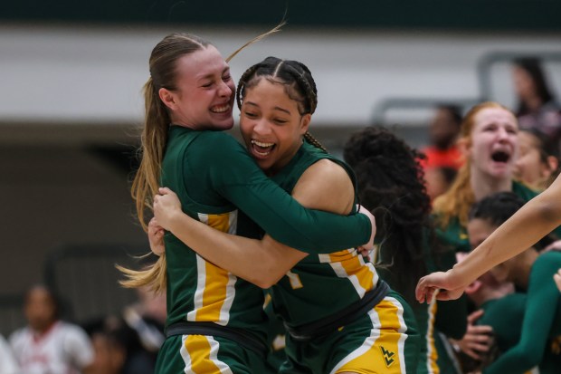 Waubonsie Valley's Hannah Laub (2) celebrates with Waubonsie Valley's Demayiah Gaines (24) after winning the Class 4A Illinois Wesleyan Supersectional against Alton in Bloomington on Monday, Feb. 26 2024. (Troy Stolt for the Aurora Beacon News)