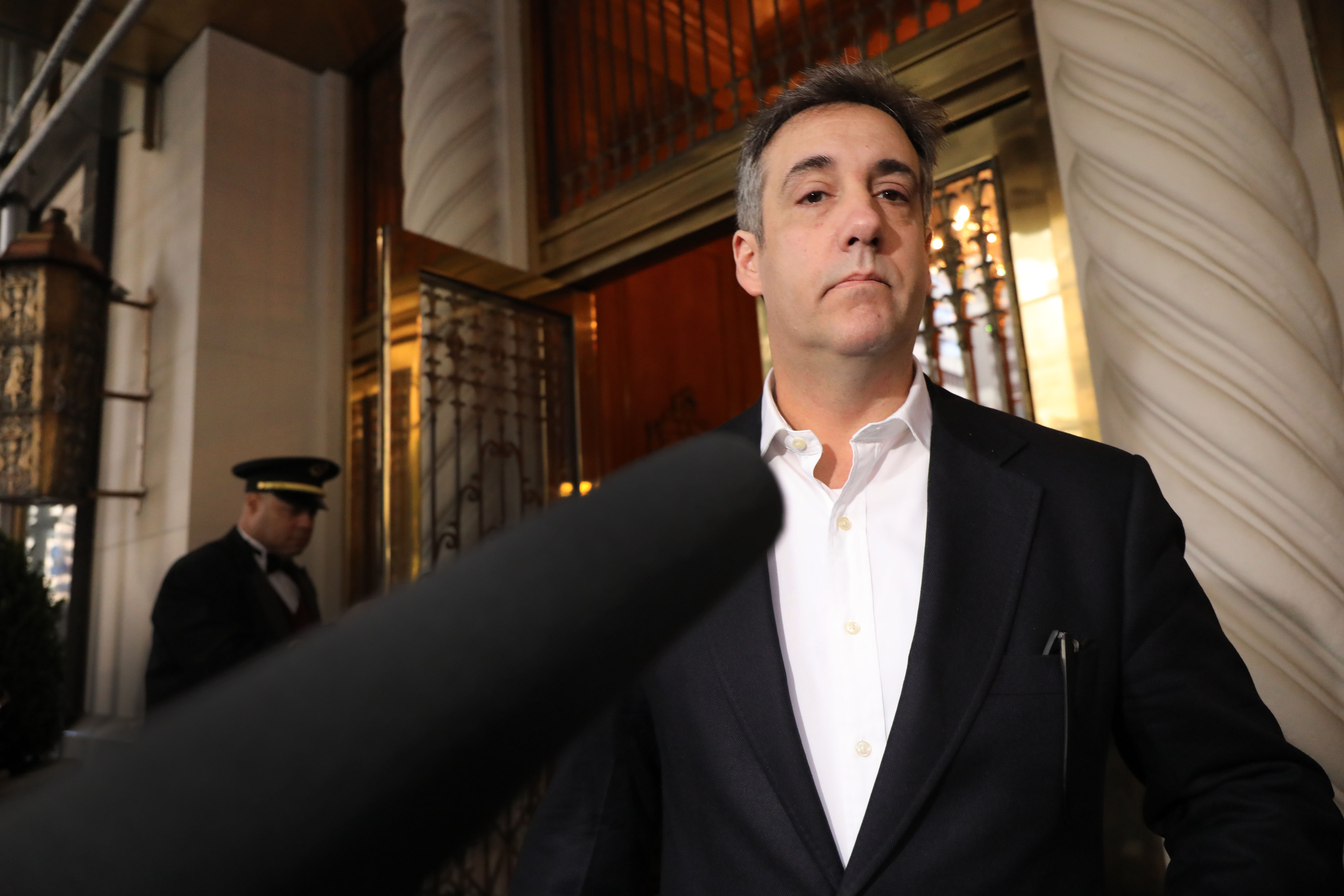 Michael Cohen in front of a microphone.