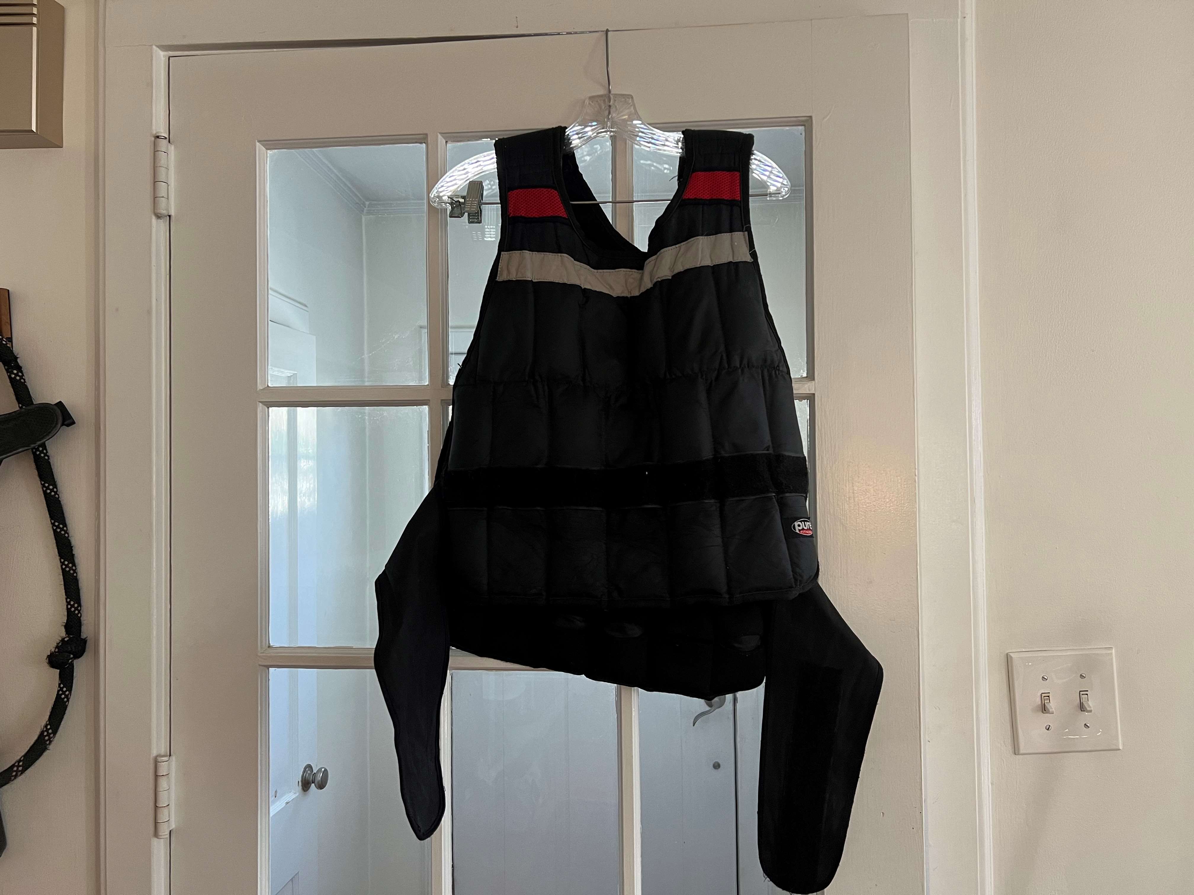 A weighted vest on a hanger