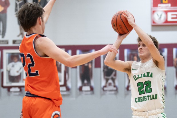 Illiana Christian guard Isaac Sherwood lines up a shot past North Newton guard Patrick Barry during the first round of the Class 2A Bowman Sectional on Wednesday, February 28, 2024. (Kyle Telechan/for the Post-Tribune)