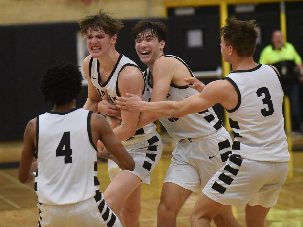 Mount Carmel's Christian Uremovich (10) gets hugged by Angelo Ciaravino (33) after sinking a shot to give the Caravan a 52-20 lead against Hyde Park with 1.2 second left during the Class 3A Hinsdale South Sectional semifinals Tuesday, February 27, 2024 in Darien, IL. (Steve Johnston/Daily Southtown)