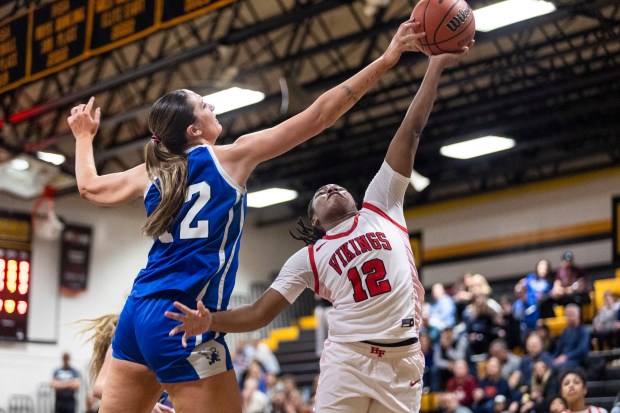 Lincoln-Way East's Hayven Smith blocks Homewood-Flossmoor's Jemiyah McDonald's shot during the Class 4A Joliet West Sectional final in Joliet on Thursday, Feb. 22, 2024. (Vincent D. Johnson / Daily Southtown)
