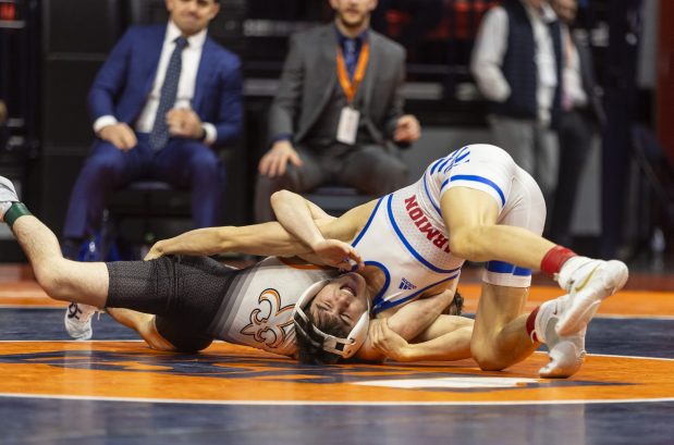 St. Charles East's Dom Munaretto, left, and Marmion's Nicholas Garcia during the 113 pound bout in the class 3Astate wrestling championship at the State Farm Center at University of Illinois in Champaign on Saturday, Feb. 17, 2024. (Vincent D. Johnson / Daily Southtown).