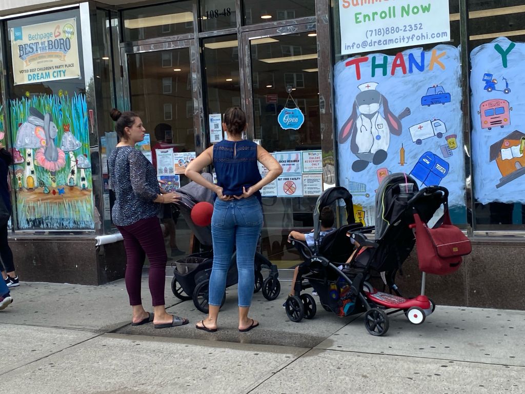 Parents wait to pick up their kids at a daycare in Queens.