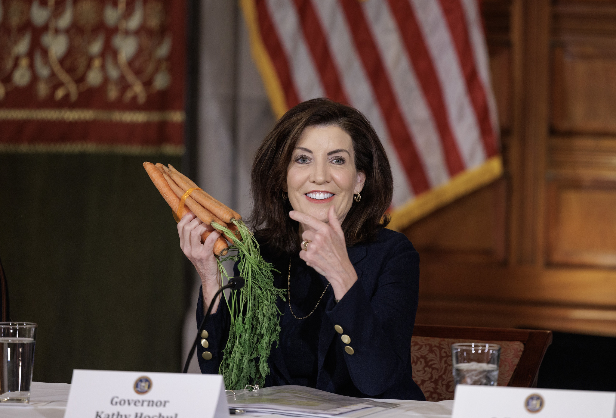 Gov. Kathy Hochul holding a bunch of carrots.
