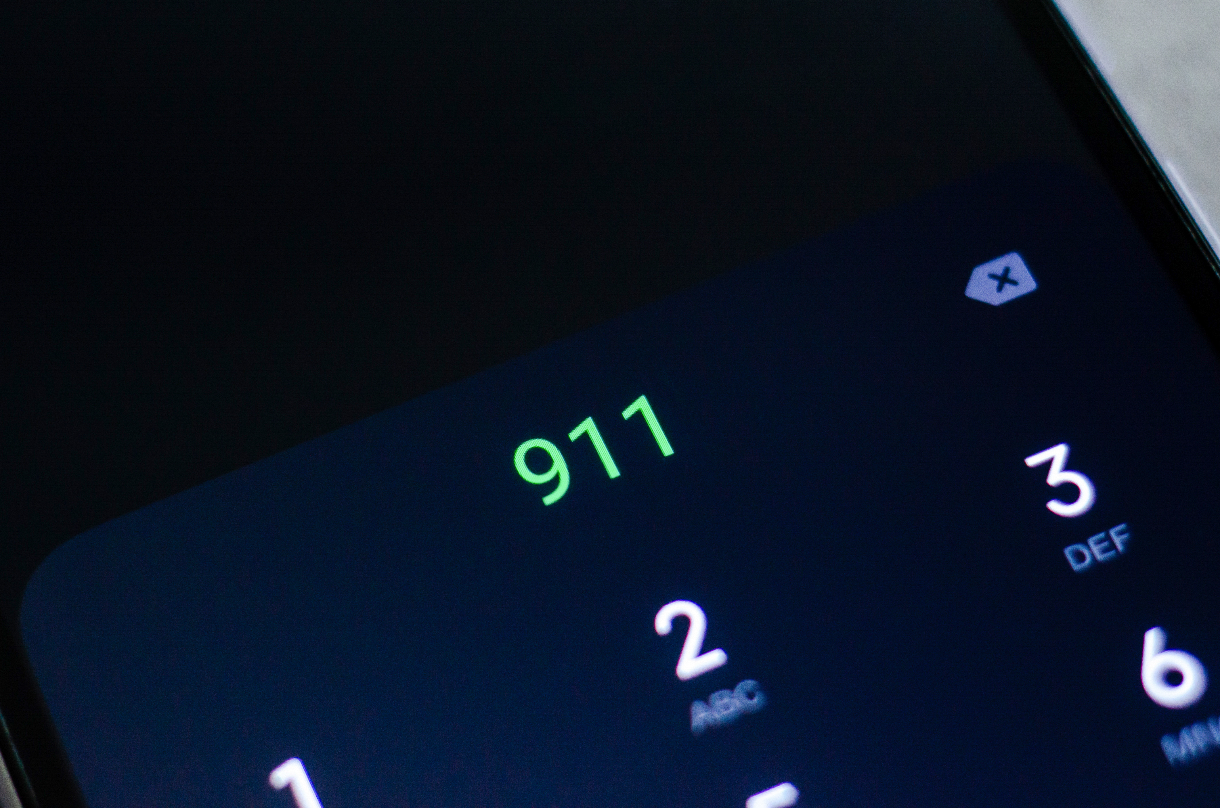 A cell phone showing 911 on its display.