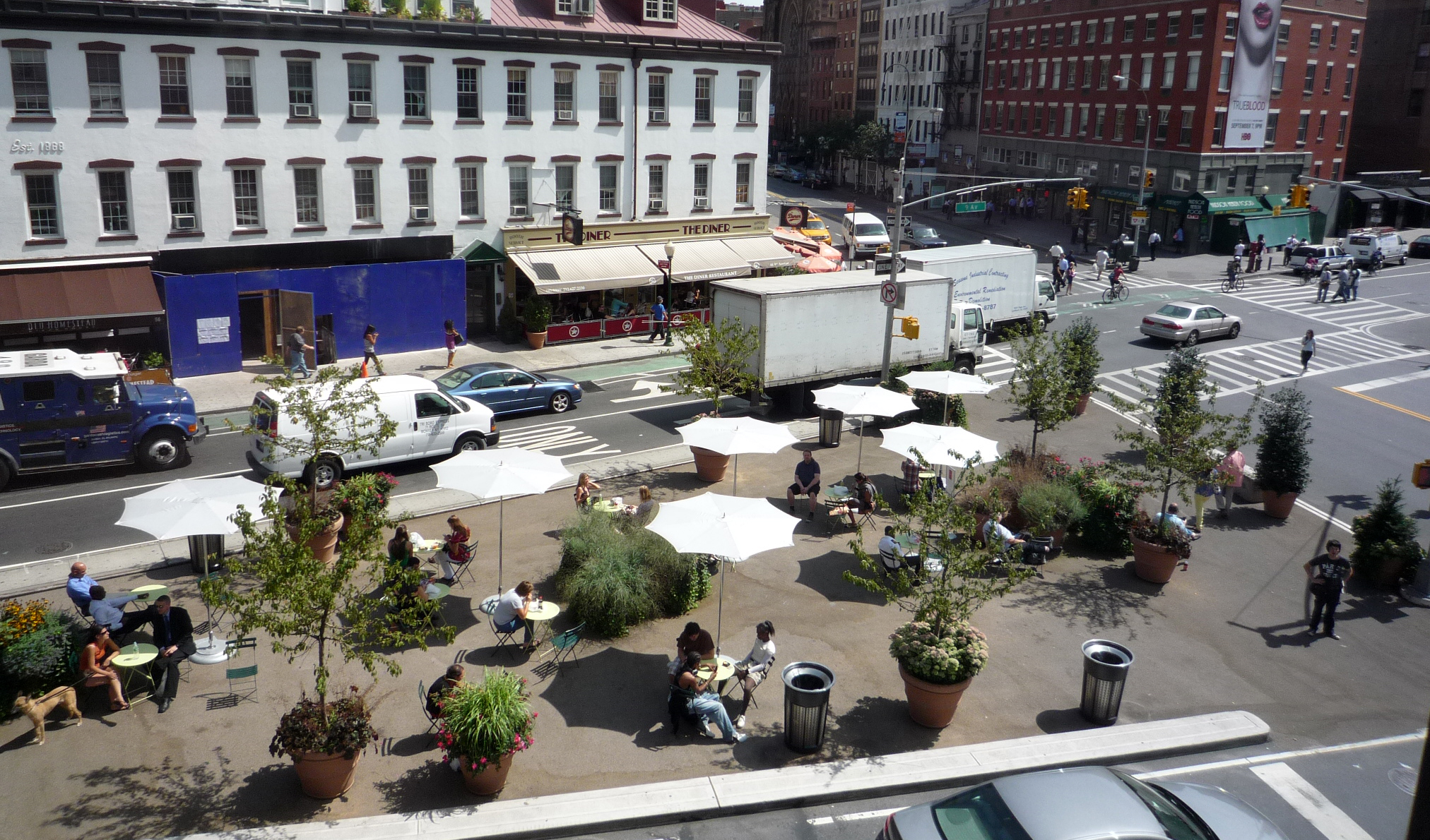 A pedestrian plaza with chairs and tables.