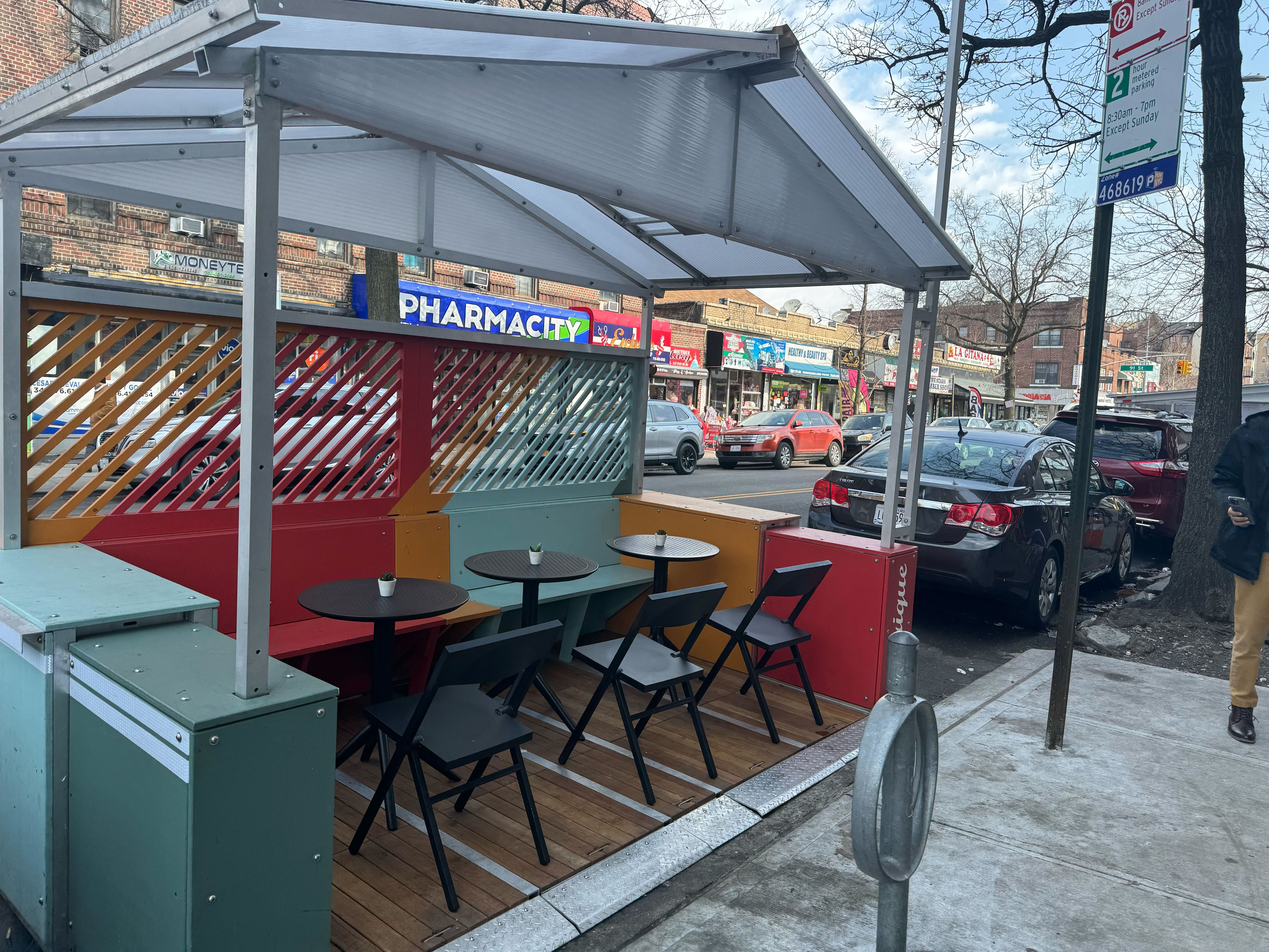 An outdoor dining shed on the street in Queens.