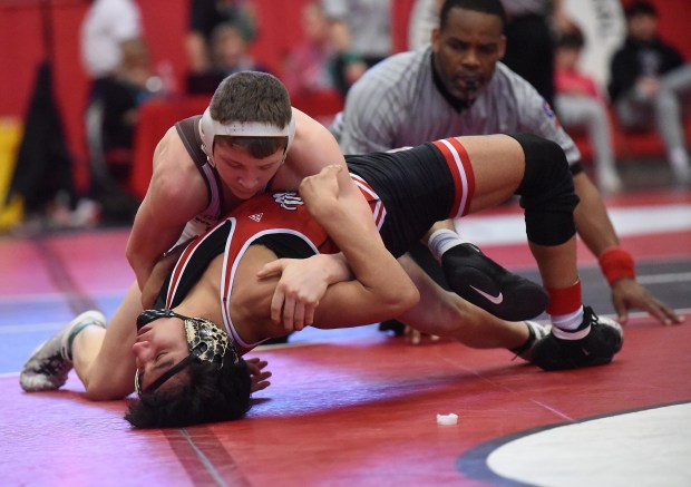 Mt. Carmel's Seth Mendoza wrestles and defeats Marist's Michael Esteban 18-3 at 126 pounds during the Class 3A Hinsdale Central Sectional Saturday, February 10, 2024 in Hinsdale, IL. (Steve Johnston/Daily Southtown)