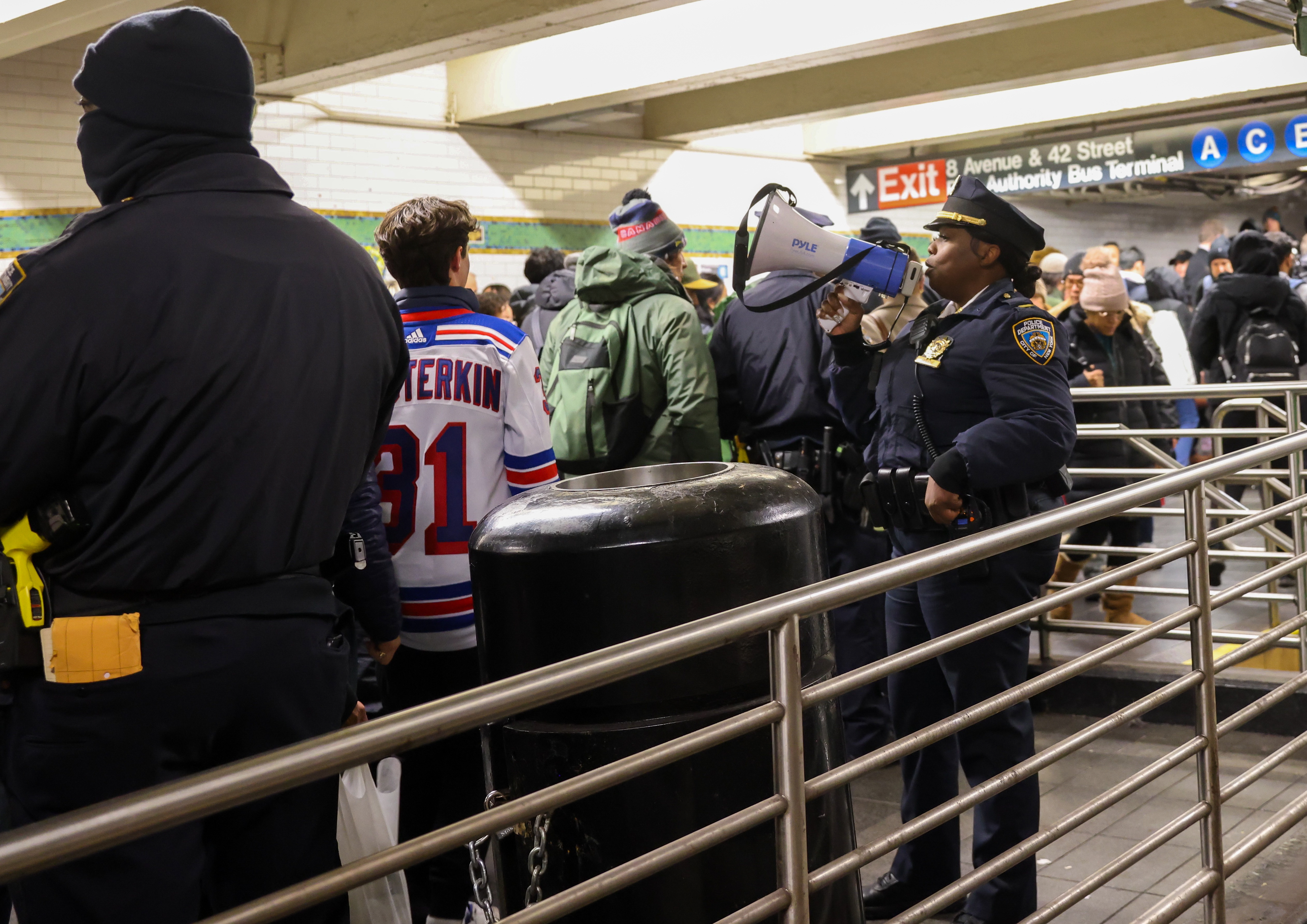A stock image of police in a crowded subway station