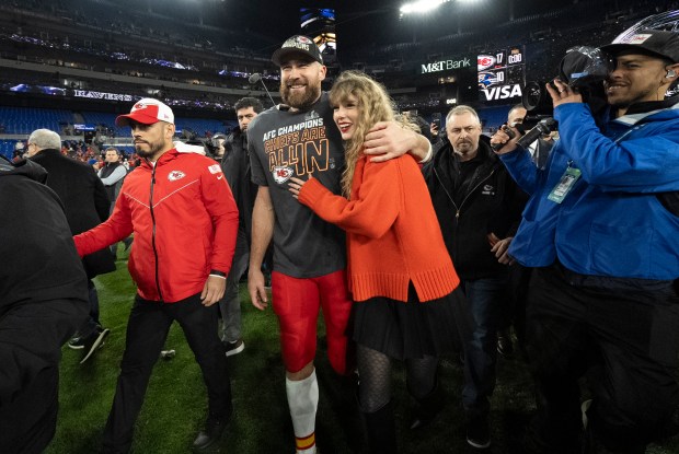 Kansas City Chiefs tight end Travis Kelce walks with Taylor Swift following the AFC Championship NFL football game between the Baltimore Ravens and the Kansas City Chiefs in Baltimore on Jan. 28, 2024. The Chiefs won 17-10. (Julio Cortez/AP)