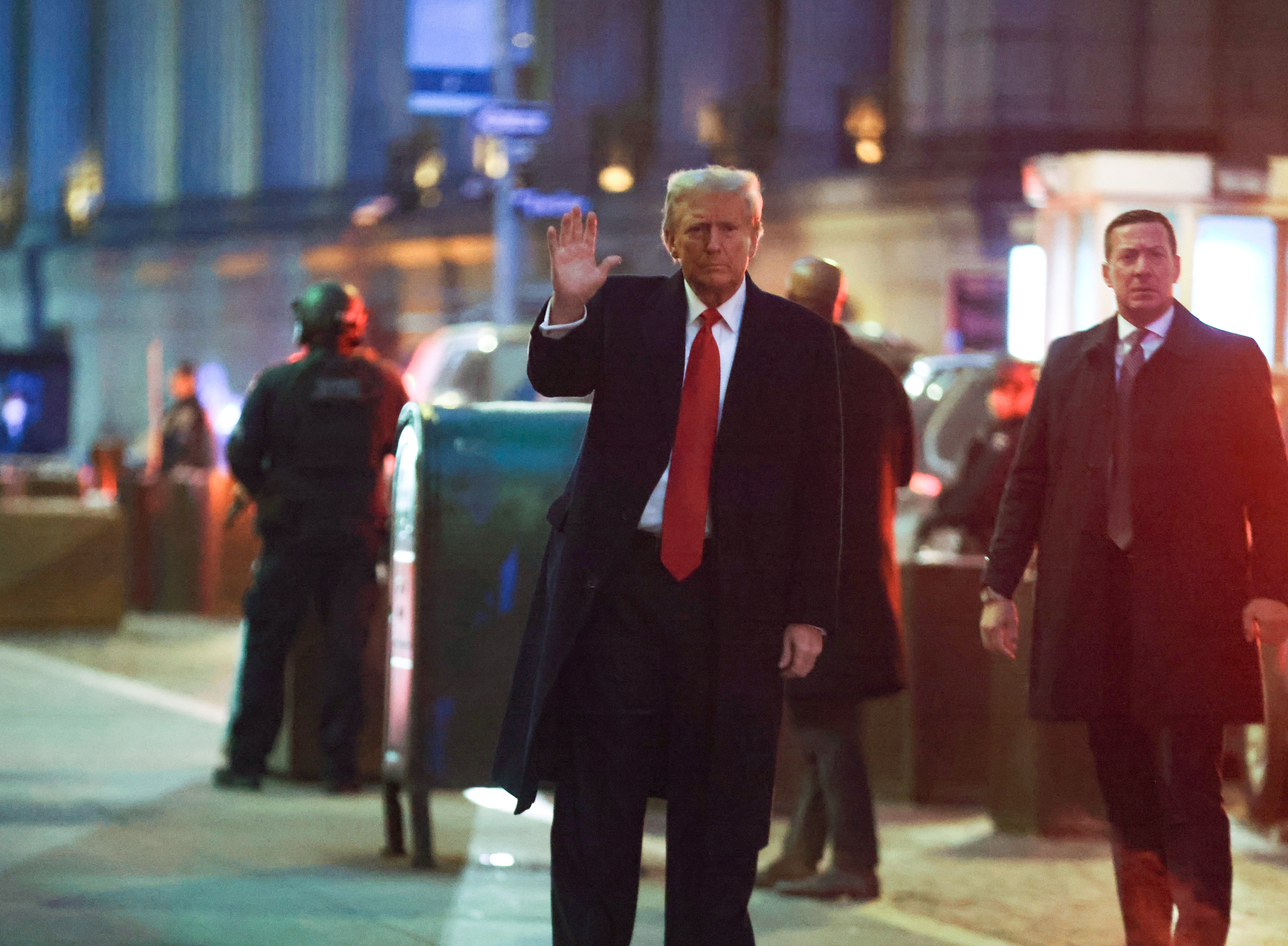 Former President Donald Trump waves as he arrives at the Trump Building.