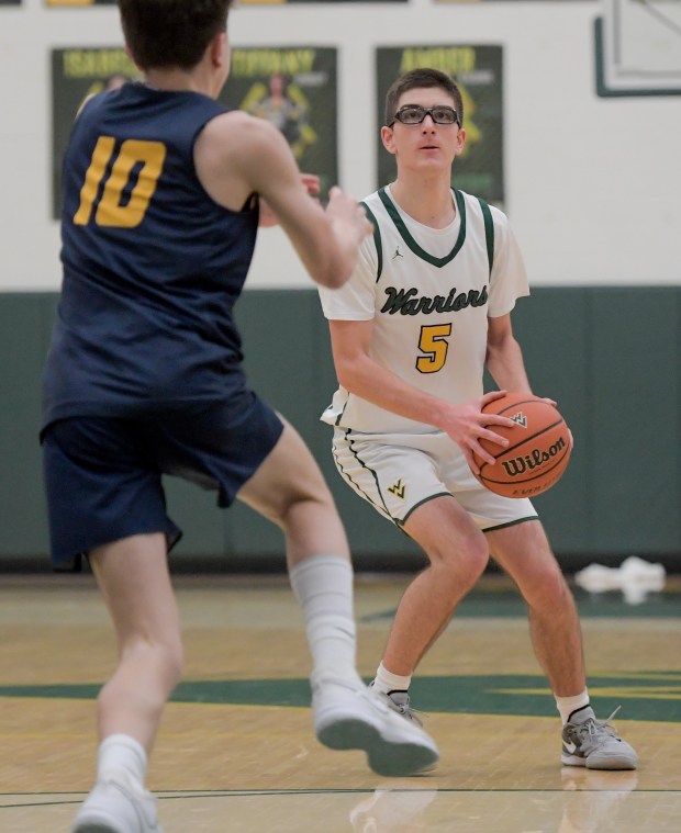 Waubonsie Valley's Ryan Morton (5) looks for an opening against Neuqua Valley's Luke Pallaschke (10) at home in Aurora on Friday, Jan. 5, 2024. (Mark Black / The Beacon-News)