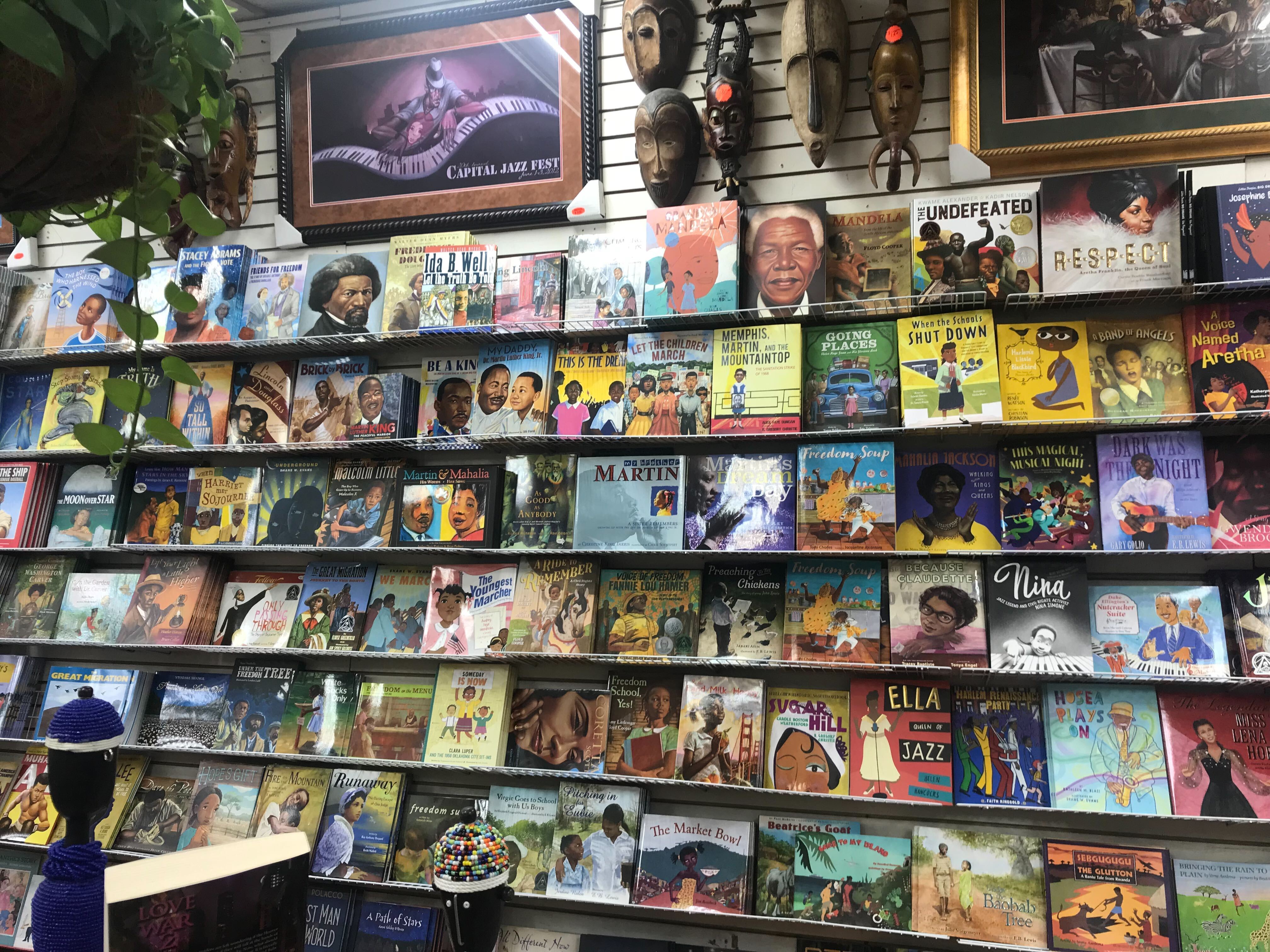 A wall full of books at the Source of Knowledge bookstore in Newark, New Jersey featuring a wide range of titles focused on the Black experience.