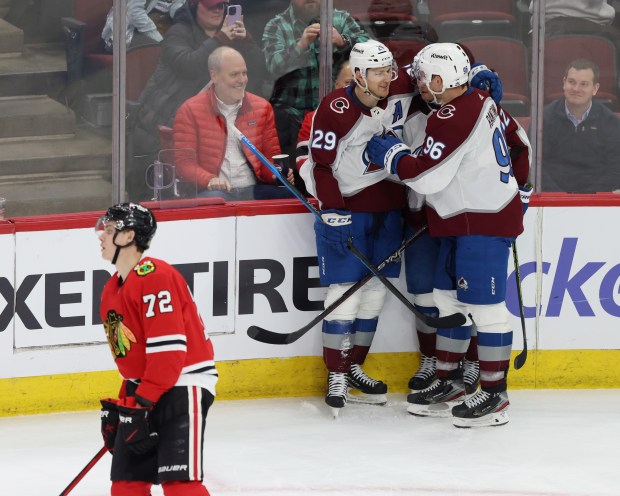 Avalanche center Nathan MacKinnon (29) and teammates celebrate after scoring a goal as Blackhawks defenseman Alex Vlasic (72) skates past in the third period on Feb. 29, 2024, at the United Center. (John J. Kim/Chicago Tribune)
