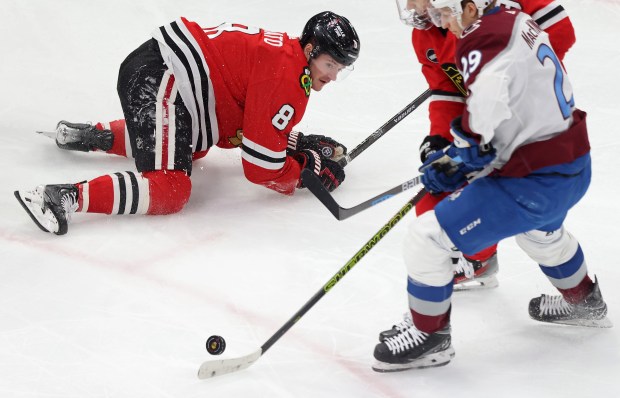 Blackhawks center Ryan Donato (8) falls to the ice while advancing the puck against the Avalanche on Feb. 29, 2024, at the United Center. (John J. Kim/Chicago Tribune)