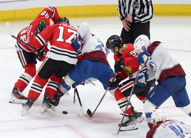 Blackhawks and Avalanche players crowd around a loose puck on Feb. 29, 2024, at the United Center. (John J. Kim/Chicago Tribune)