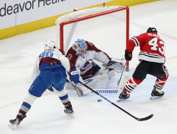 Avalanche goaltender Justus Annunen (60) deflects a shot on goal from Blackhawks center Colin Blackwell (43) in the first period on Feb. 29, 2024, at the United Center. (John J. Kim/Chicago Tribune)