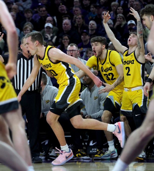 The Iowa Hawkeyes bench reacts after a 3-pointer by forward Payton Sandfort (20) in the second half against Northwestern at Welsh-Ryan Arena in Evanston on March 2, 2024. (Chris Sweda/Chicago Tribune)