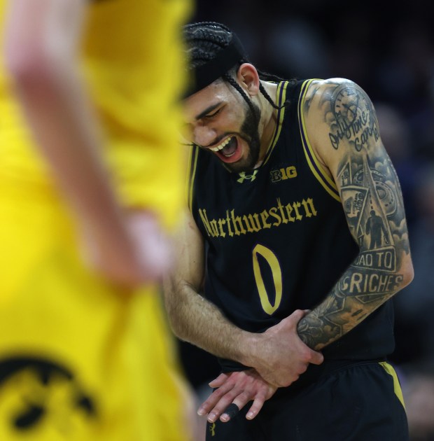Northwestern guard Boo Buie (0) reacts after suffering an injury in the second half against Iowa at Welsh-Ryan Arena in Evanston on March 2, 2024. (Chris Sweda/Chicago Tribune)